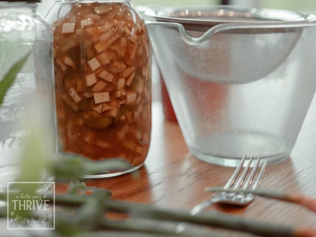 Homemade fire cider macerating and ready for straining